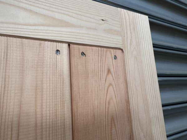 Close up of the detailing on a wooden garage side door