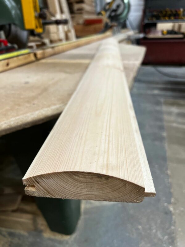 Premium grade wooden loglap cladding, pictured in workshop.