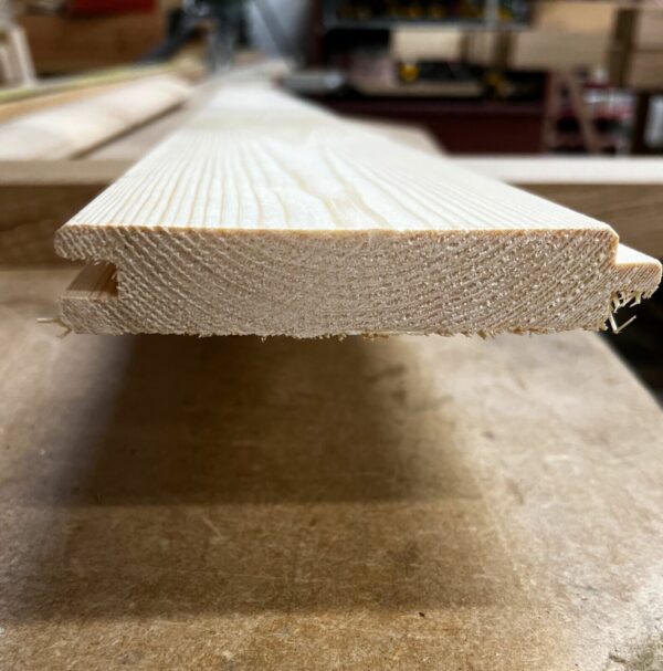 End of a length of tongue and groove 21mm match board cladding on workbench