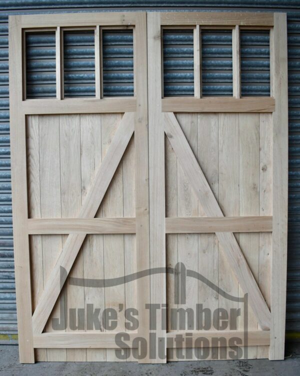 6 pan oak garage door pictured outside against metal shutters, showing the detailing of the door.