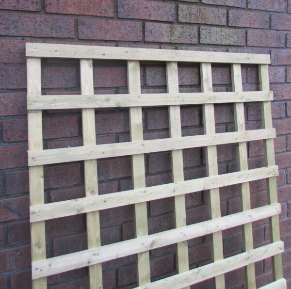 6x4 wooden square trellis leant up against brick wall