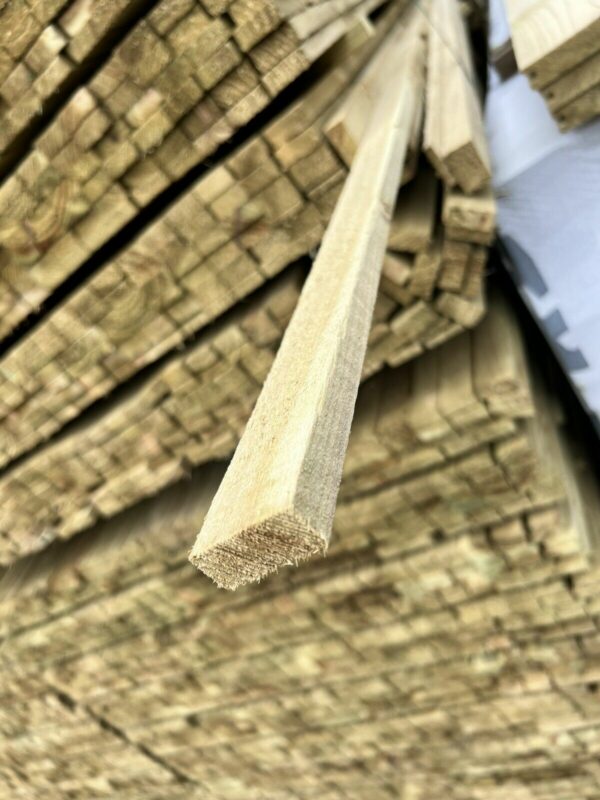 A length of tanalised timber, pulled out from a stack of wood in wood yard.