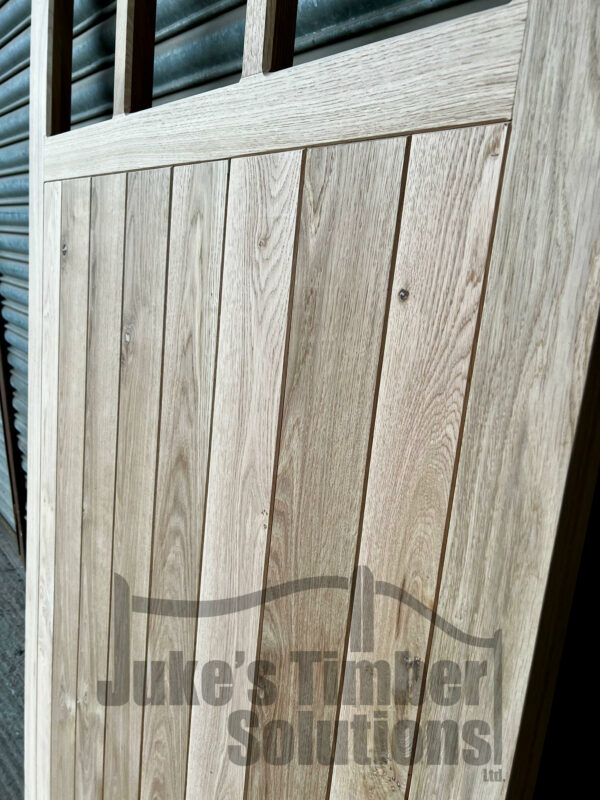Close up of detailing and craftsmanship on the lower portion of a 3 pane oak side door