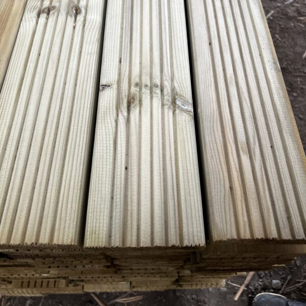 Close up image of treated wooden timber decking boards