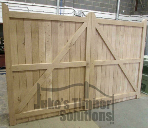 Rear of an oak driveway gate, showing framed, ledged and braced detaling, pictured in Juke's Timber Solutions workshop