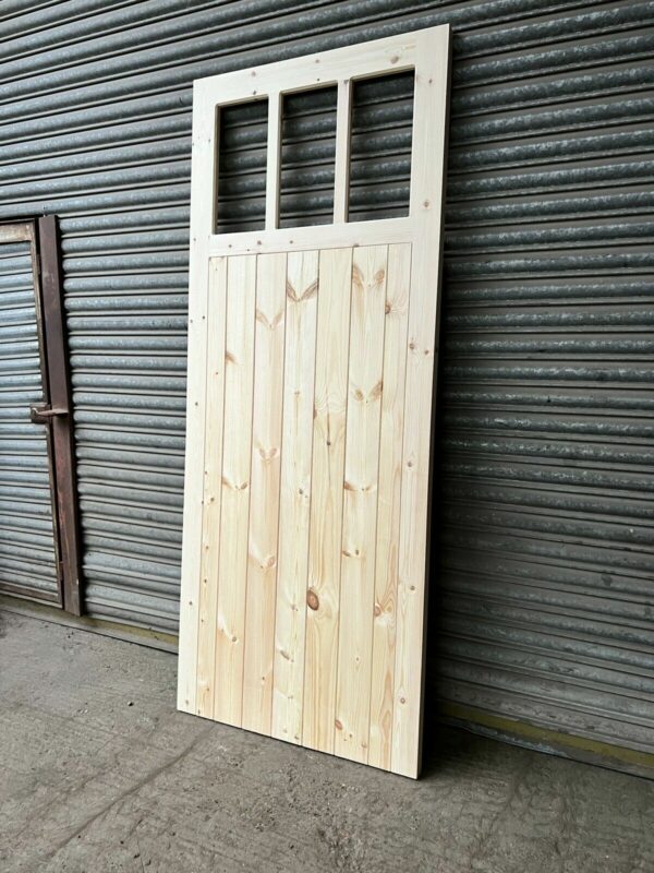 3 pane heavy duty wooden side garage door, leaning against metal shutters