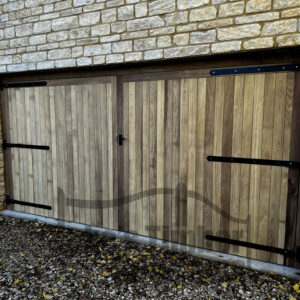 Iroko garage door installed into stone building