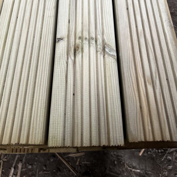 Lengths of treated wooden timber decking