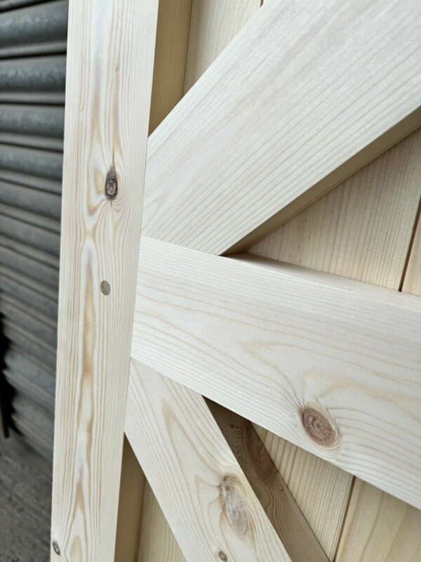 Close up of the detailing and craftsmanship of a framed, ledged and braced wooden side garage door.