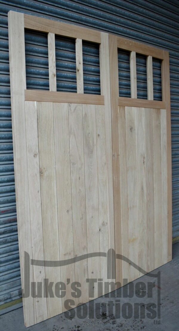 6 pane wooden oak garage doors, leaning against metal shutters