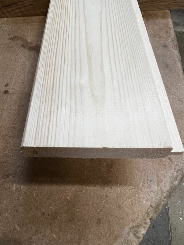 Close up of the top of 21mm match board tongue and groove cladding