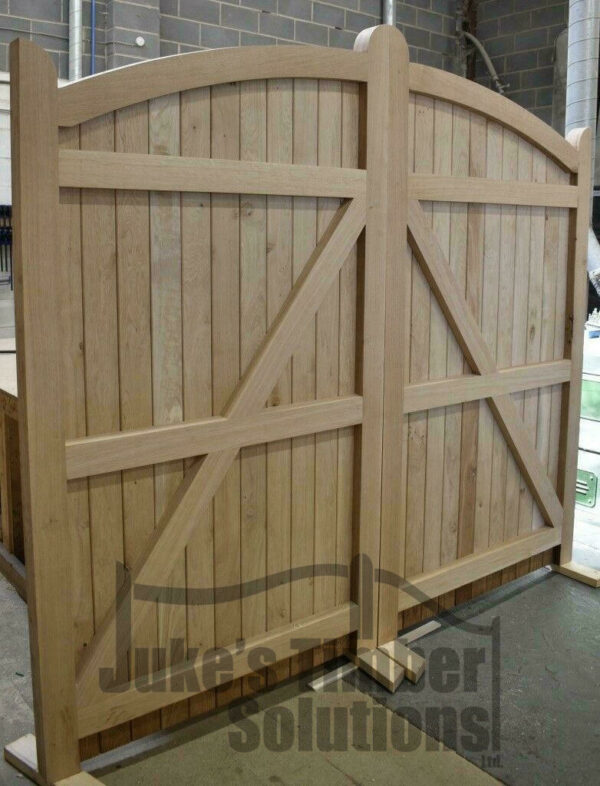 Oak bow top driveway gate standing in workshop