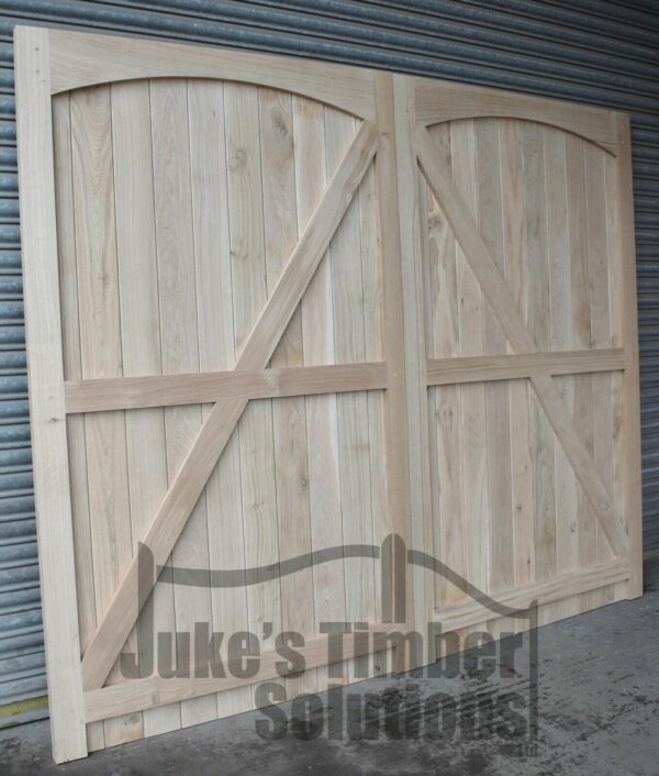 Rear of a hardwood garage door with curved detailing and framing, ledging and bracing