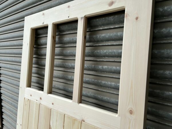 Close up on panes of 3 pane wooden side garage door