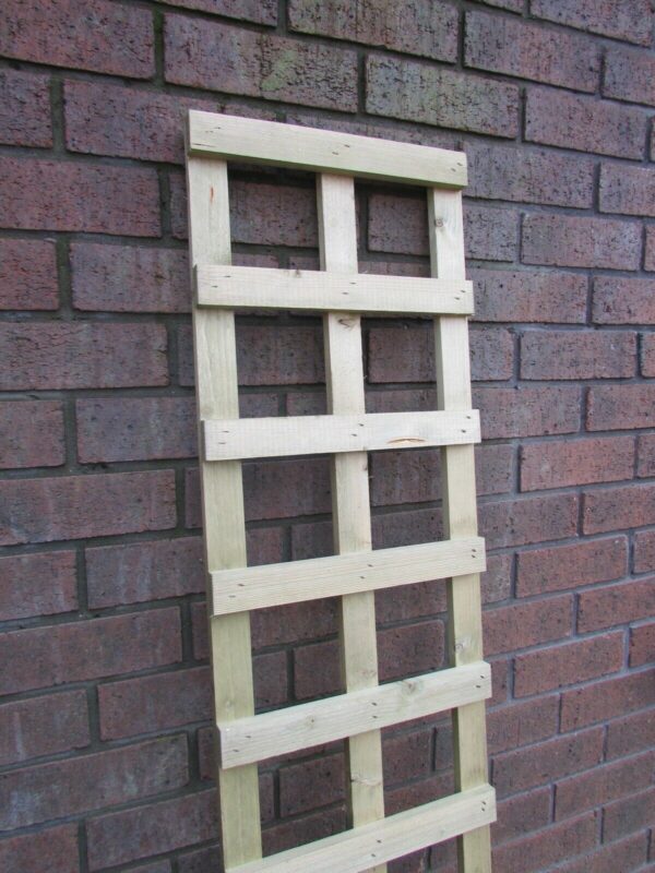 6x1 wooden square trellis leant against red brick wall