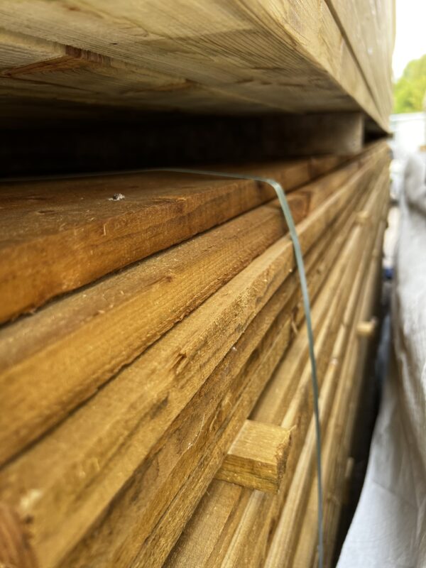 Stacked packs of tanalised rough sawn timber in wood yard