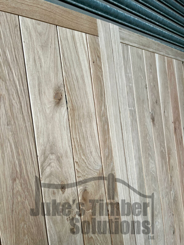 Showing a close up of the centre detailing on a full board oak garage door
