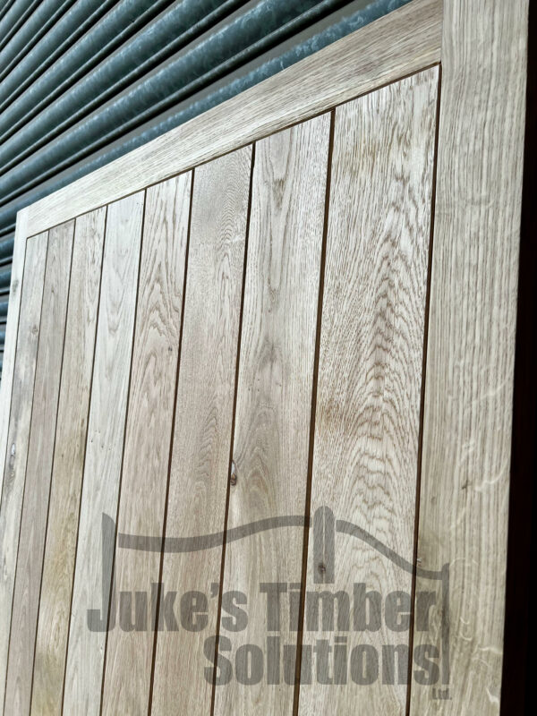Close up on the detailing of an oak super heavy duty garage side door