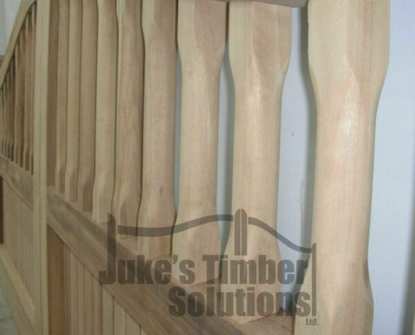 Close up of right hand side spindling in Iroko swan neck palisade driveway gates