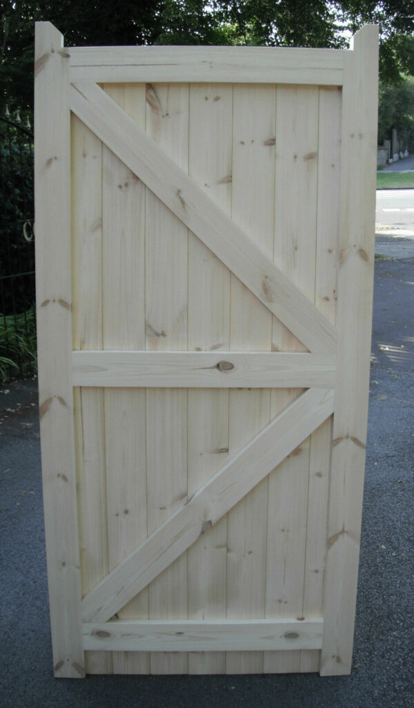 Rear of a framed, ledged and braced wooden garden gate, showing the detailing and structure of the gate.