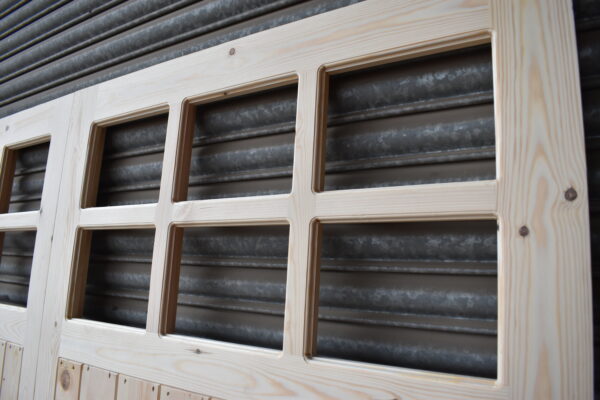 Close up of 6 panes in a 12 pane wooden garage door