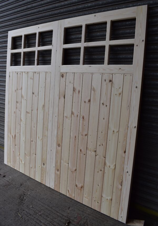 12 Pane Wooden Framed, Ledged and Braced Garage Door leaning against a metal shutter