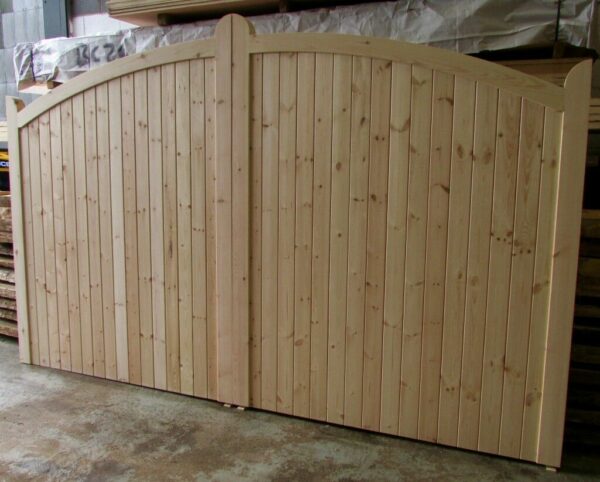 Wooden softwood bow top driveway gates in workshop