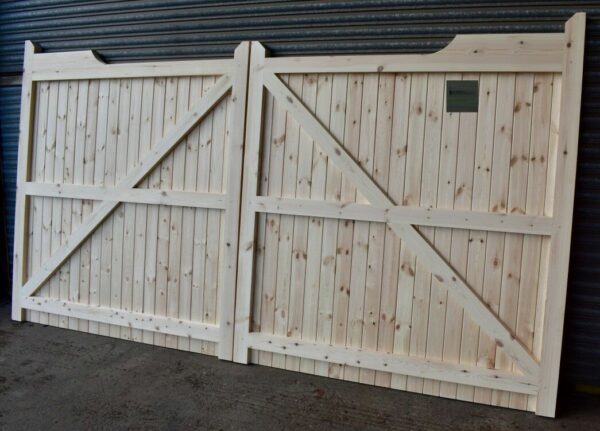 Softwood gun stock driveway gates leaning against metal shutters