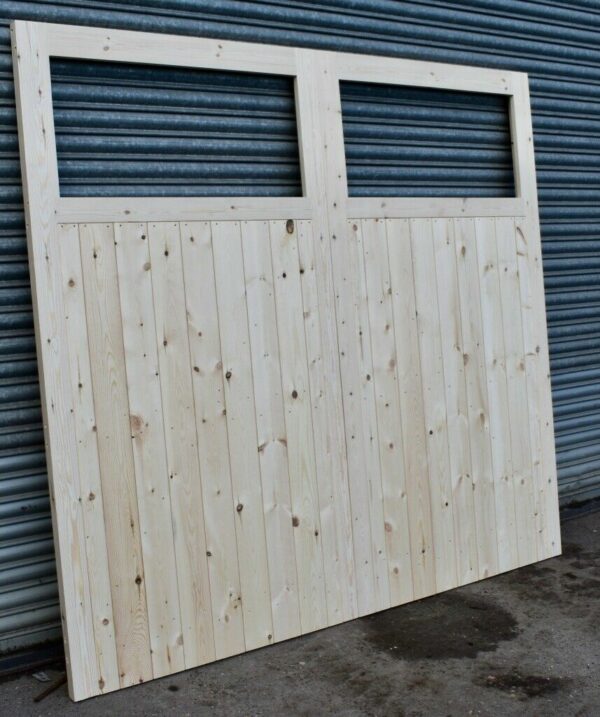 Wooden single pane garage doors in front of metal shutters