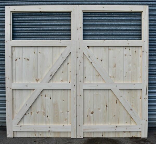 Rear of wooden garage doors showing framed and ledged detailing