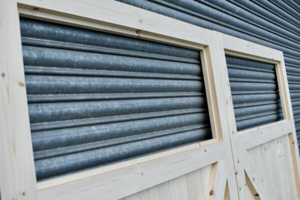 Close up of the single pane on a set of heavy duty wooden garage doors