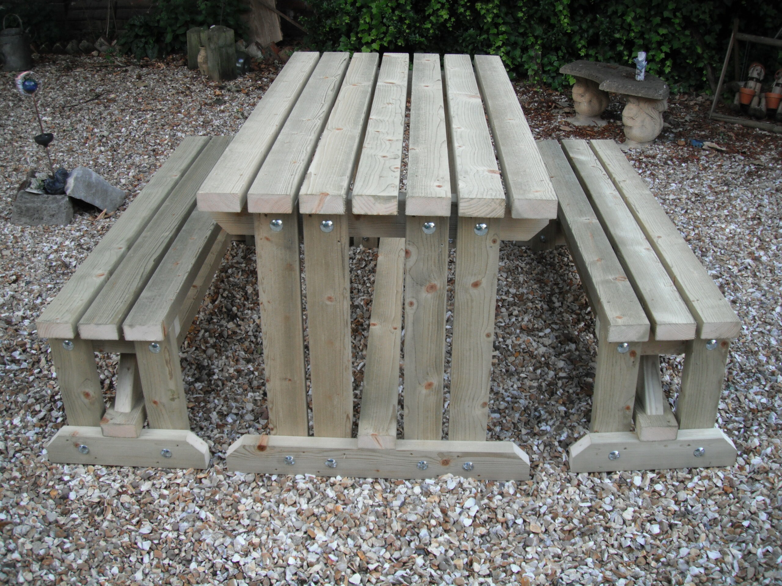 Wooden walk in picnic bench in garden on gravel