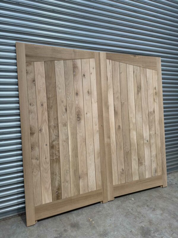 Oak garage door with angled detailing pictured leaning against metal shutters